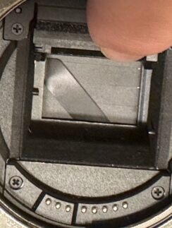 a finger on a camera lens