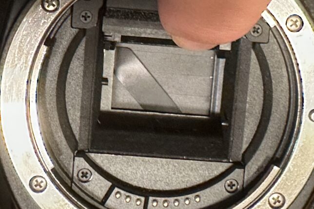 a finger on a camera lens