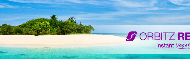 a beach with trees and blue water