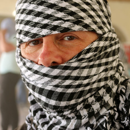 a person with a scarf over their head
