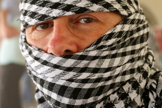 a person with a scarf over their head