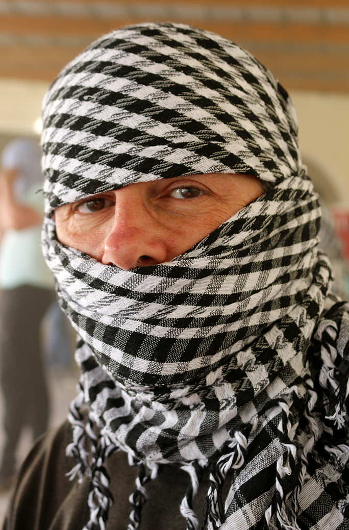 a person with a scarf over their head