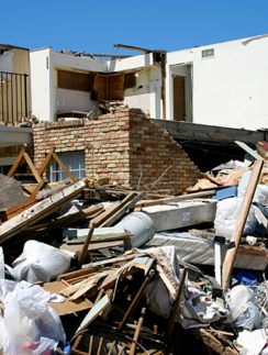 a pile of debris next to a house