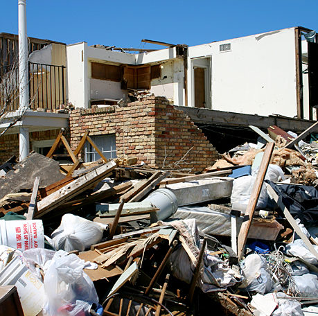 a pile of debris next to a house