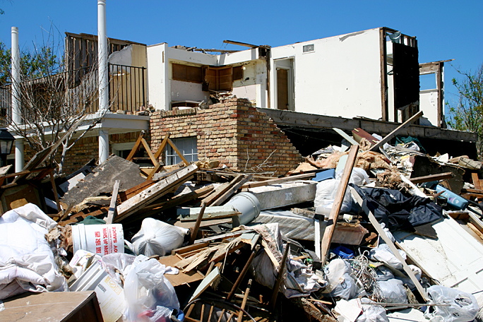 a pile of debris next to a house