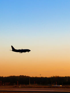 Airplane landing sunset