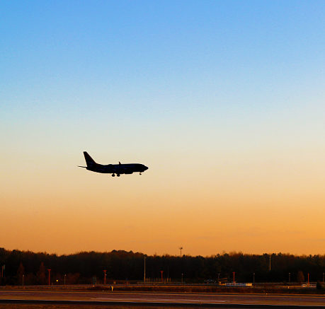 Airplane landing sunset