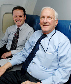 a few men sitting in an airplane