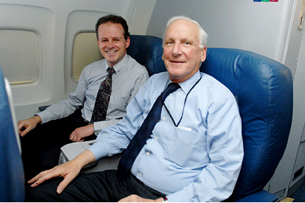 a few men sitting in an airplane