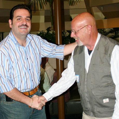 a man shaking hands with another man