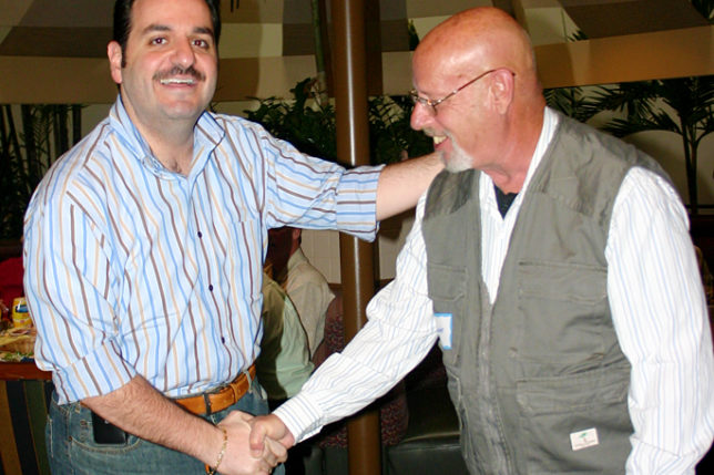 a man shaking hands with another man