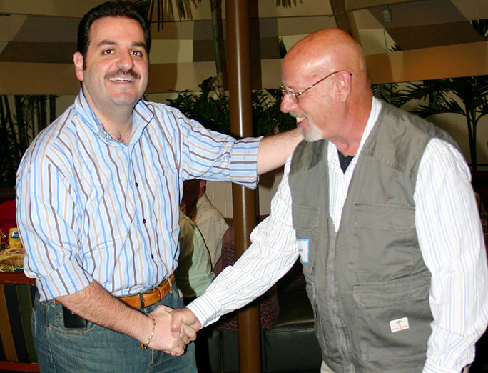 a man shaking hands with another man