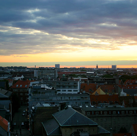 a city with many buildings and a sunset