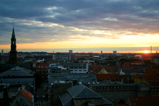 a city with many buildings and a sunset