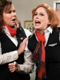 two women in uniform with red hair and black vests