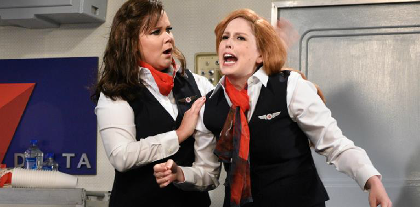 two women in uniform with red hair and black vests