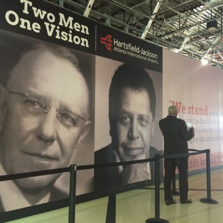 a man standing in front of a large sign