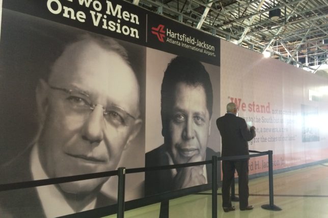 a man standing in front of a large sign