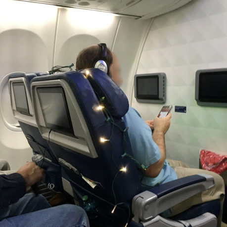 Christmas lights around airplane seat