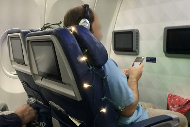 Christmas lights around airplane seat
