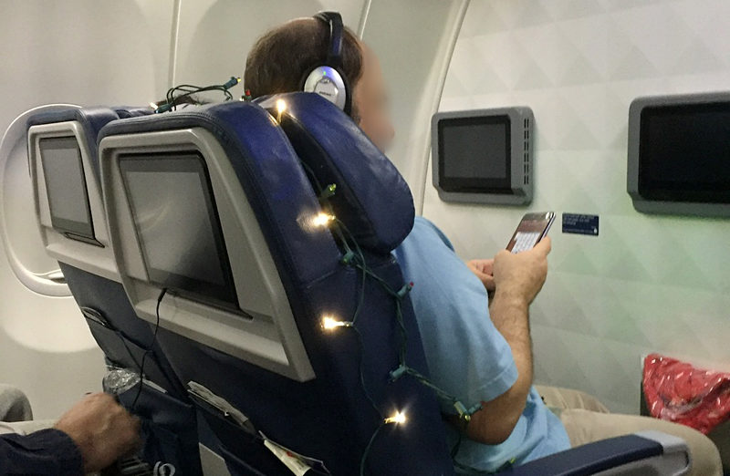 Christmas lights around airplane seat