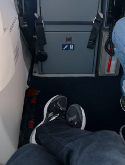 Exit row seat extra legroom rear of MD-88 airplane