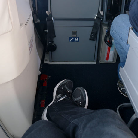 Exit row seat extra legroom rear of MD-88 airplane
