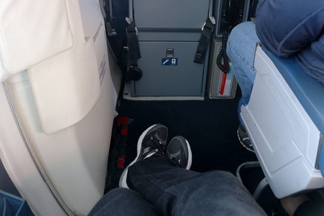 Exit row seat extra legroom rear of MD-88 airplane