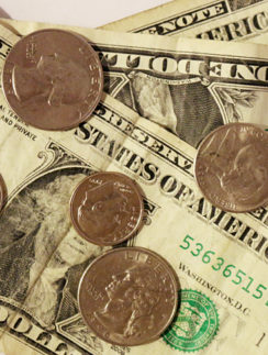 Dollar bills and coins for tip or gratuity