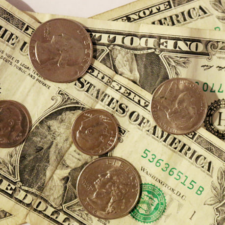 Dollar bills and coins for tip or gratuity