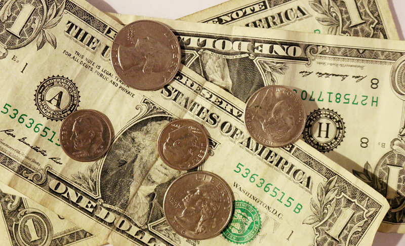 Dollar bills and coins for tip or gratuity
