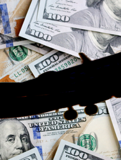 Airplane Silhouette Over $100 Bills