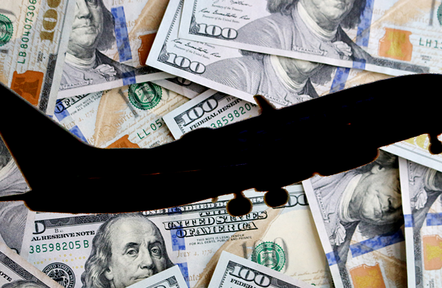 Airplane Silhouette Over $100 Bills