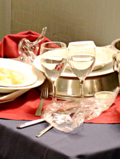 Room service used dishes and glasses on cart in hallway