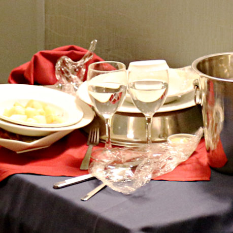Room service used dishes and glasses on cart in hallway