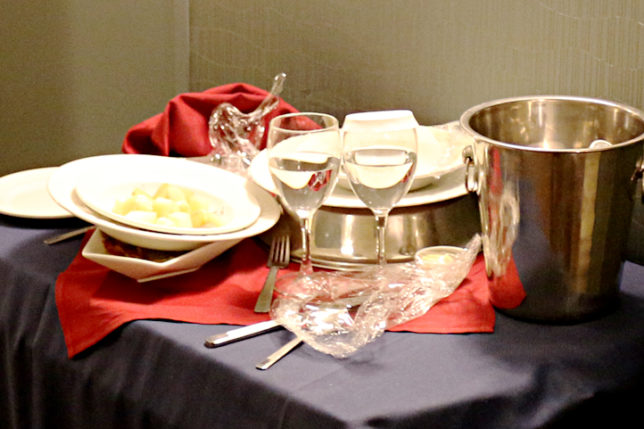 Room service used dishes and glasses on cart in hallway