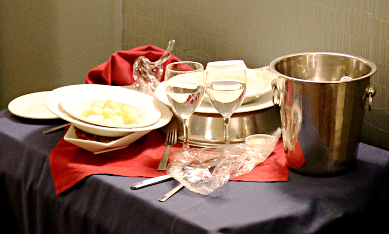Room service used dishes and glasses on cart in hallway