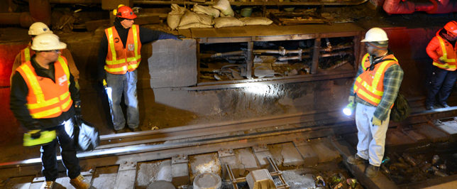 Surveying track damage in Canarsie Tunnel