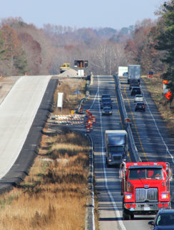 a road with cars and trucks on it