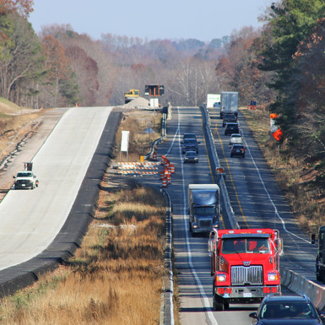 a road with cars and trucks on it