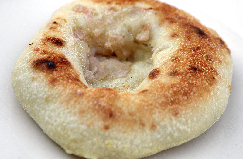 a round brown bread with a hole in it