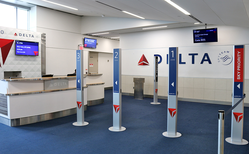 branded pillars boarding gate Delta Air Lines