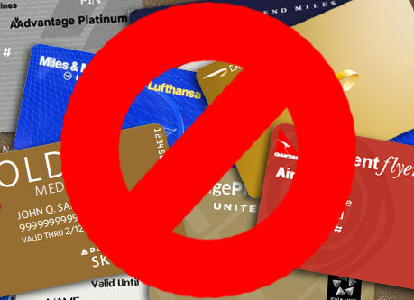 a red circle with a sign over a group of credit cards
