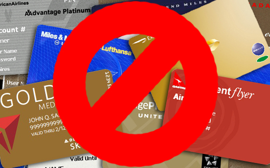 a red circle with a sign over a group of credit cards