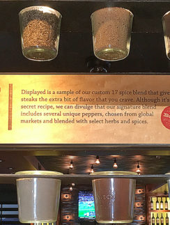 a group of glass jars with spices from a shelf