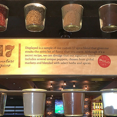 a group of glass jars with spices from a shelf