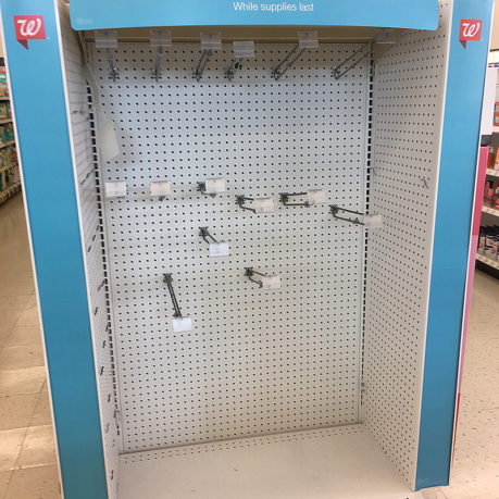 a large display case with pegs and hooks