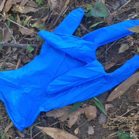 a blue glove on the ground