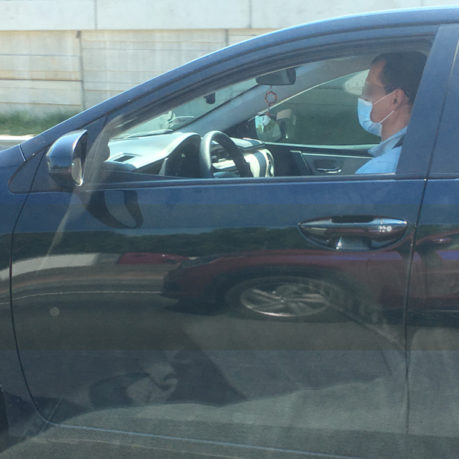 a man in a car wearing a mask
