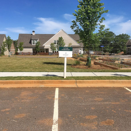 a sign in front of a parking lot